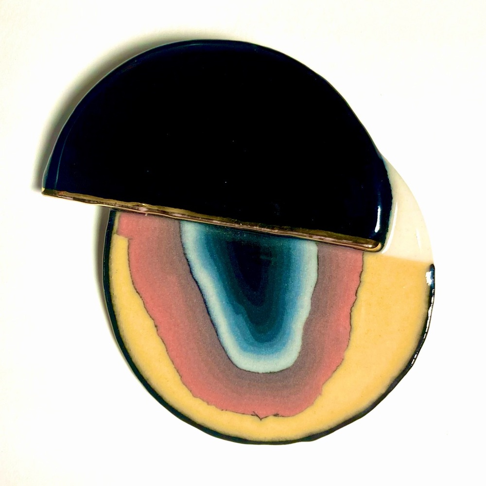 Ceramic simulated agate brooch with shiny glaze.